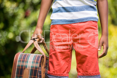 Close up view of Child holding a bag