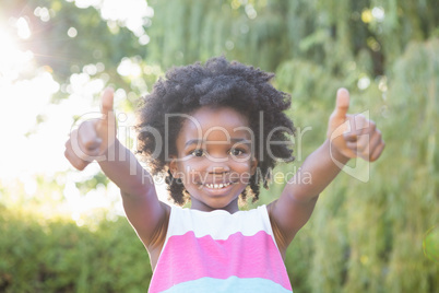 Smiling child with thumbs up