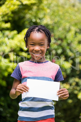 A little boy is holding a poster