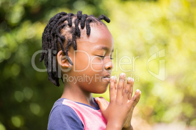 Focused boy with hands together