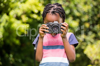 A child is taking picture with camera