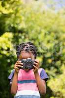A child is taking picture with camera