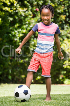 Smiling boy kicking the ball