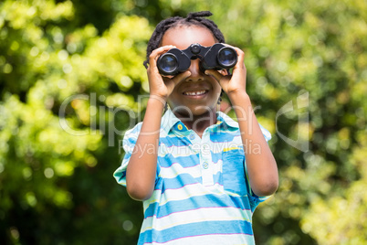 Smiling boy using magnifying glass