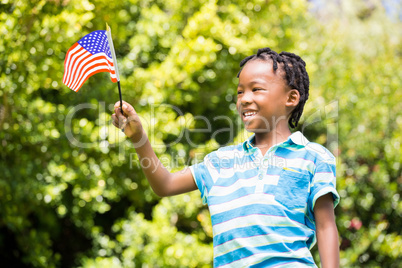 Smiling boy waving american flag