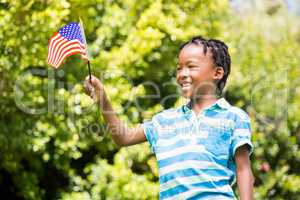 Smiling boy waving american flag