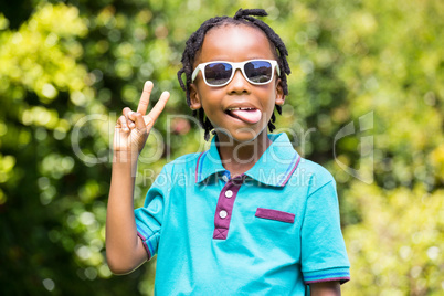 Boy with outstretched tongue wearing sunglasses