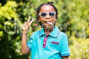 Boy with outstretched tongue wearing sunglasses