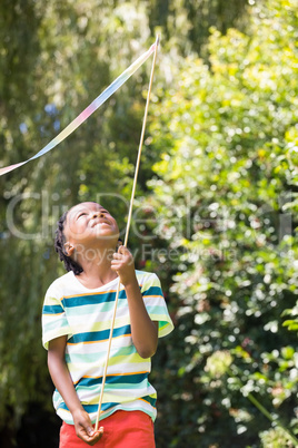 A kid is playing with a stick