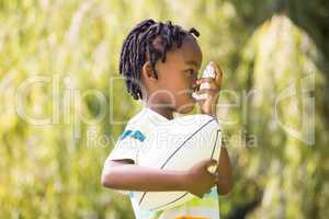 Child is using an asthma inhaler