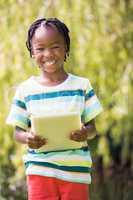 Portrait of kid holding a tablet computer