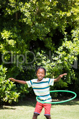 A kid playing with a hoop