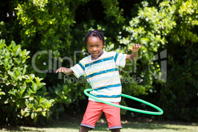 A kid playing with a hoop