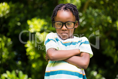 A kid posing with his arms crossed