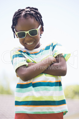 Portrait of kid crossing his arms and smiling