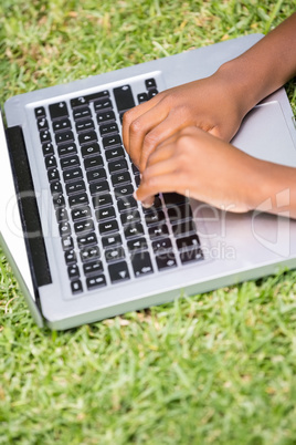 Close up of kid playing with his laptop