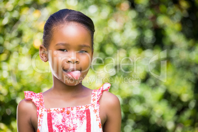 Portrait of kid sticking her tongue out