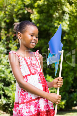 Portrait of cute girl smiling and holding a windmill