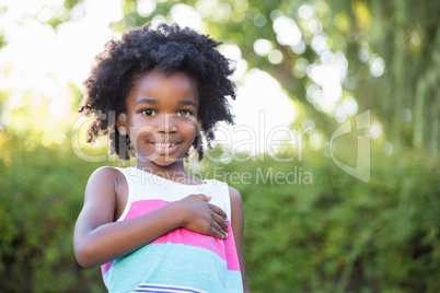 A little girl is touching her heart