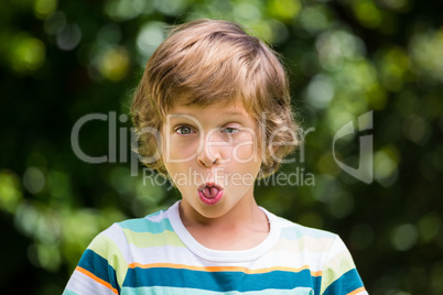 A little boy is making a funny face