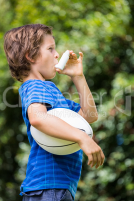 A little boy is breathing an asthma medication