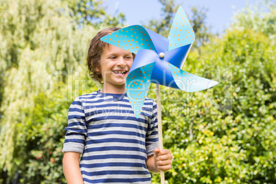 Cute boy smiling and holding a windmill