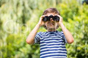 Portrait of cute boy using binoculars