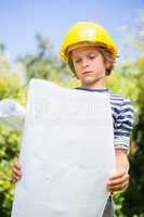 Portrait of cute boy pretending to be a worker