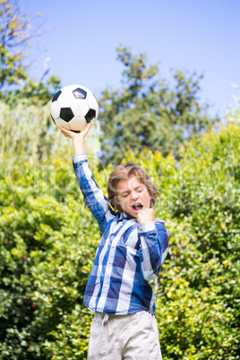 Portrait of cute boy celebrating his soccer victory