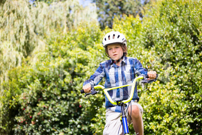 Portrait of boy smiling and riding bike