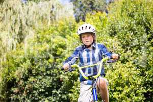 Portrait of boy smiling and riding bike