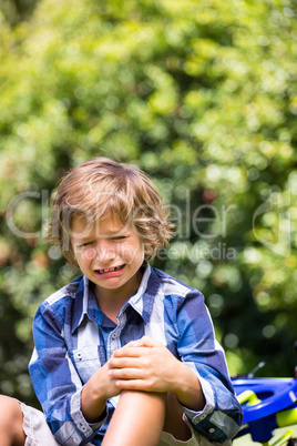 Portrait of cute boy crying cause of his bike fall
