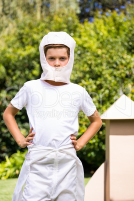 A kid dressed with a costume is watching the lens