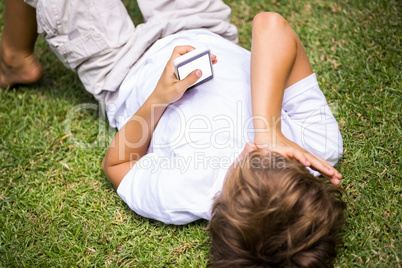 Child lying using a smartphone