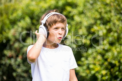 Child listening music with headphone
