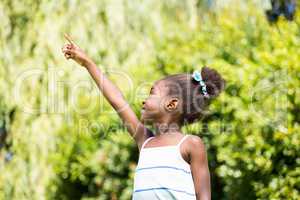 Mixed-race girl pointing the sky