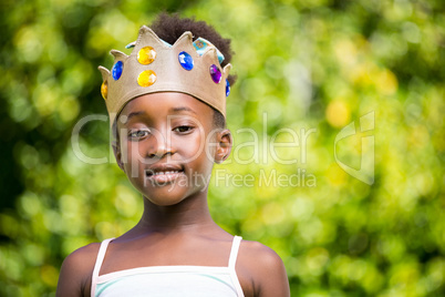 Portrait of a mixed-race girl smiling and wearing a crown