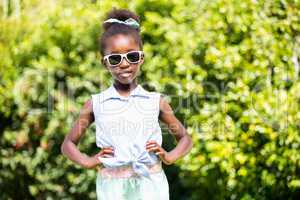 Cute mixed-race girl posing with sunglasses