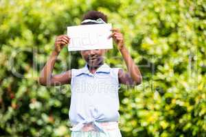 Cute mixed-race girl holding a paper with help message