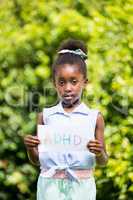 Cute mixed-race girl holding a paper with a message