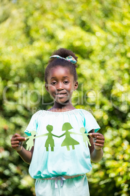 Cute mixed-race girl holding a paper tinsel