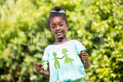 Cute mixed-race girl holding a paper tinsel
