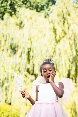 Cute mixed-race girl wearing a fairy dress