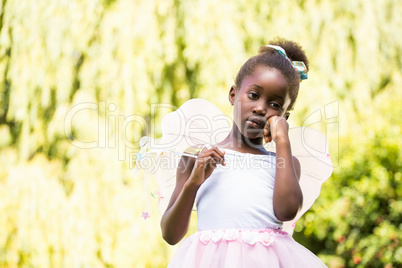 Cute mixed-race girl posing and wearing a fairy dress