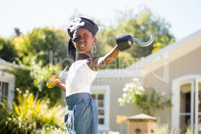 Cute mixed-race girl grimacing and wearing pirate clothes