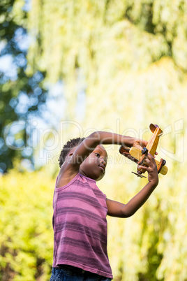 Cute mixed-race boy playing with a little plane