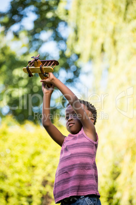 Cute mixed-race boy playing with a little plane