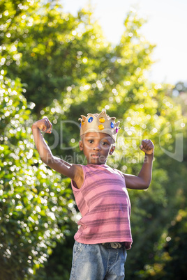 Boy putting arms up with crown