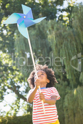 Happy boy is playing with pinwheel