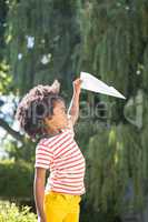 Boy is playing with a paper plane